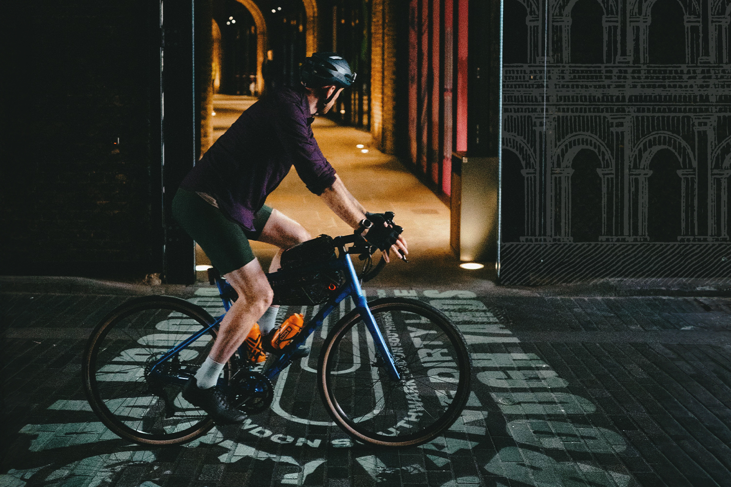 Stapleford on his bike passing through an ornate tunnel.
