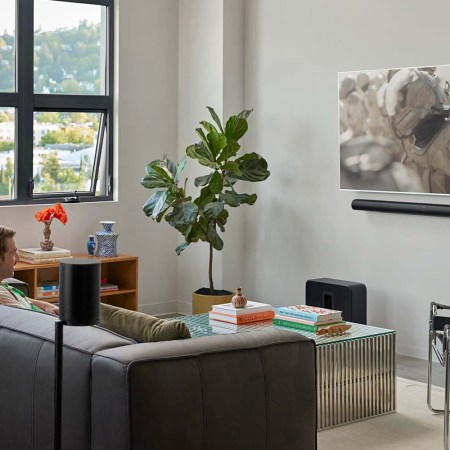 Sonos Arc Ultra and Sub 4 in a living room with a couple watching TV