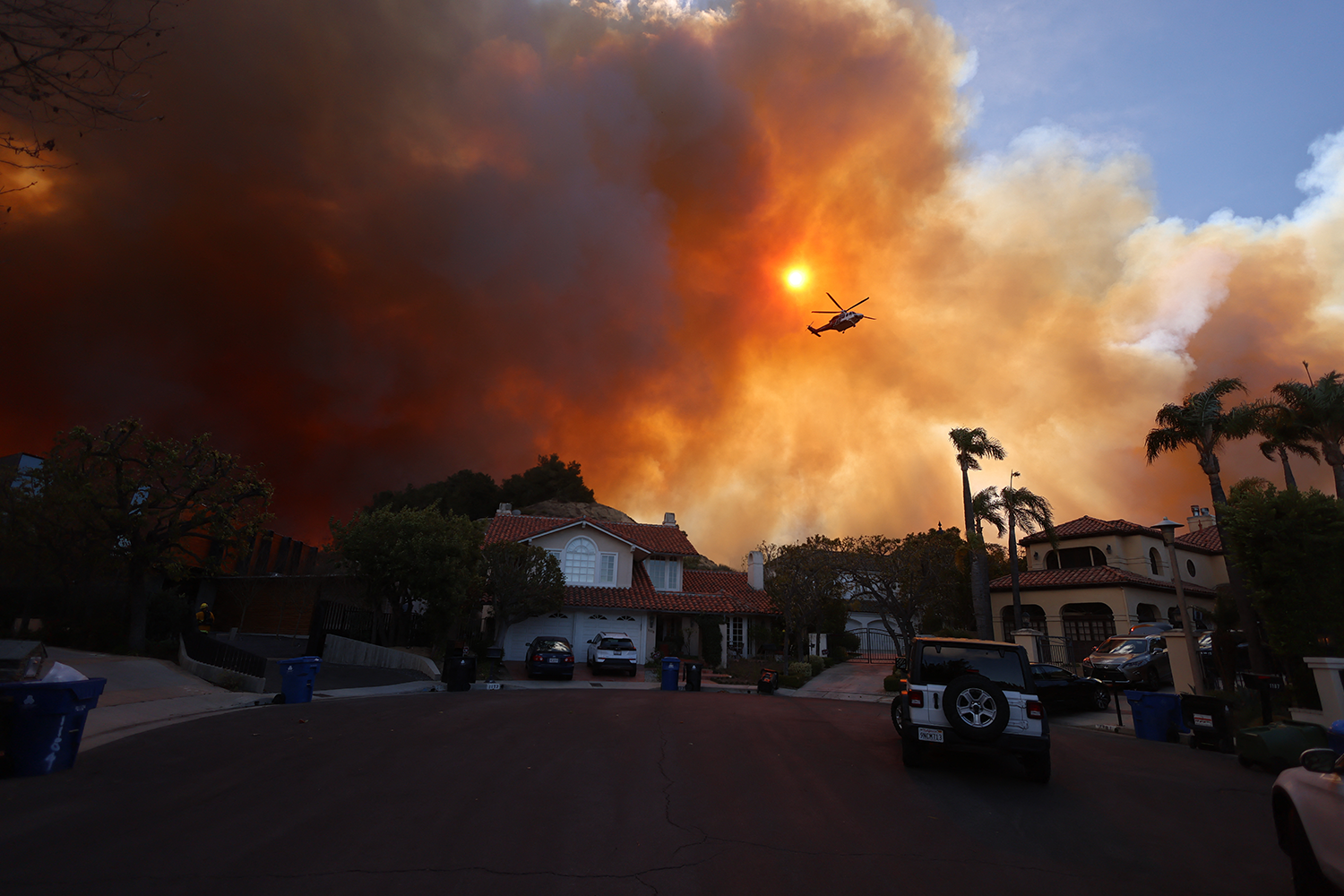 Plumes of smoke are seen as a brush fire burns in Pacific Palisades on Tuesday