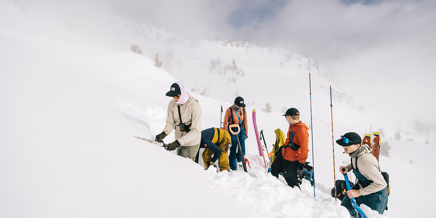 A group of skiers standing in the snow on a mountain in the Southern Wallowas