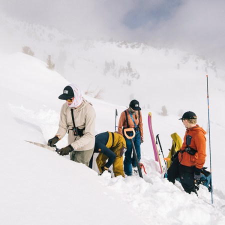 A group of skiers standing in the snow on a mountain in the Southern Wallowas