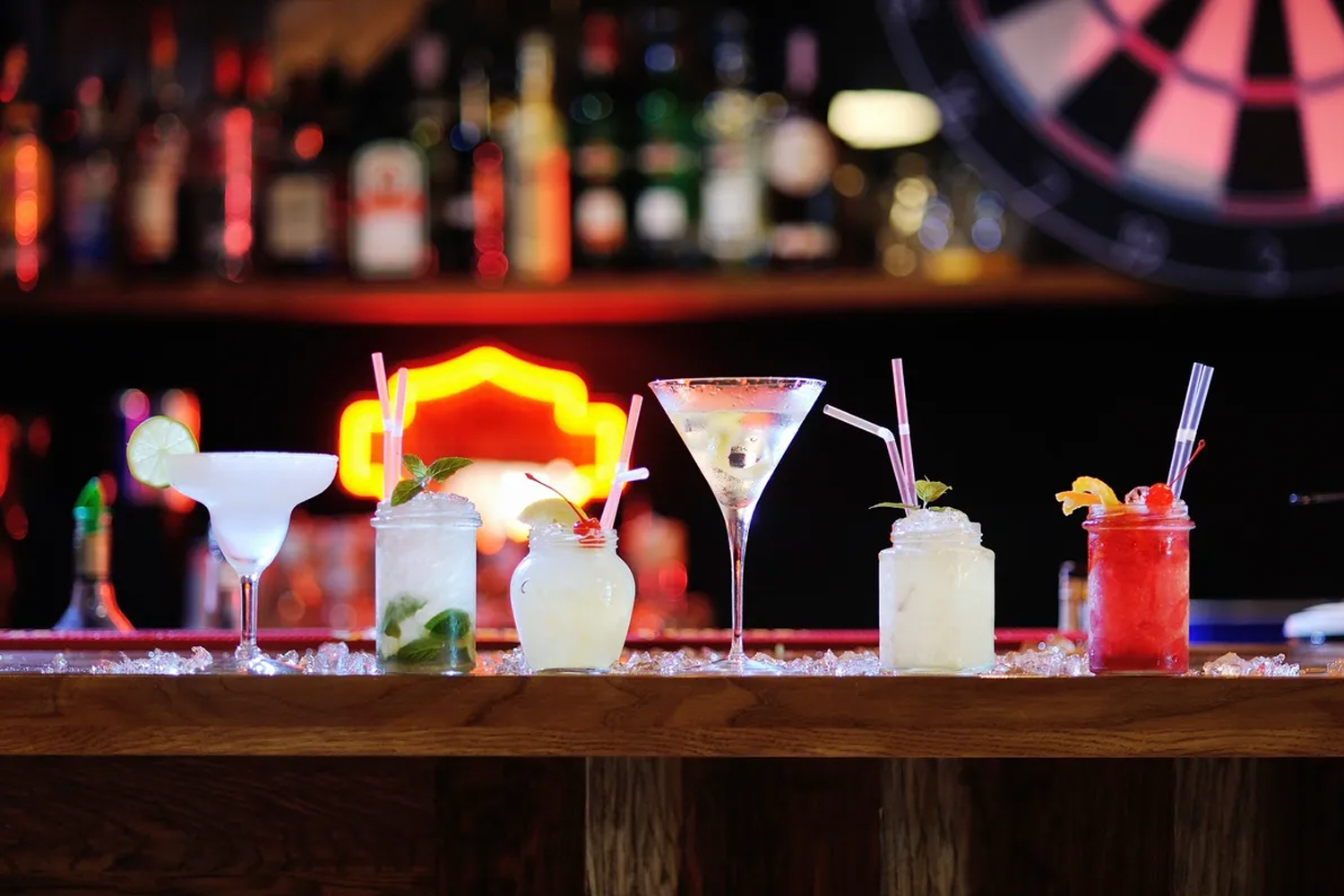a lineup of cocktails on a bar