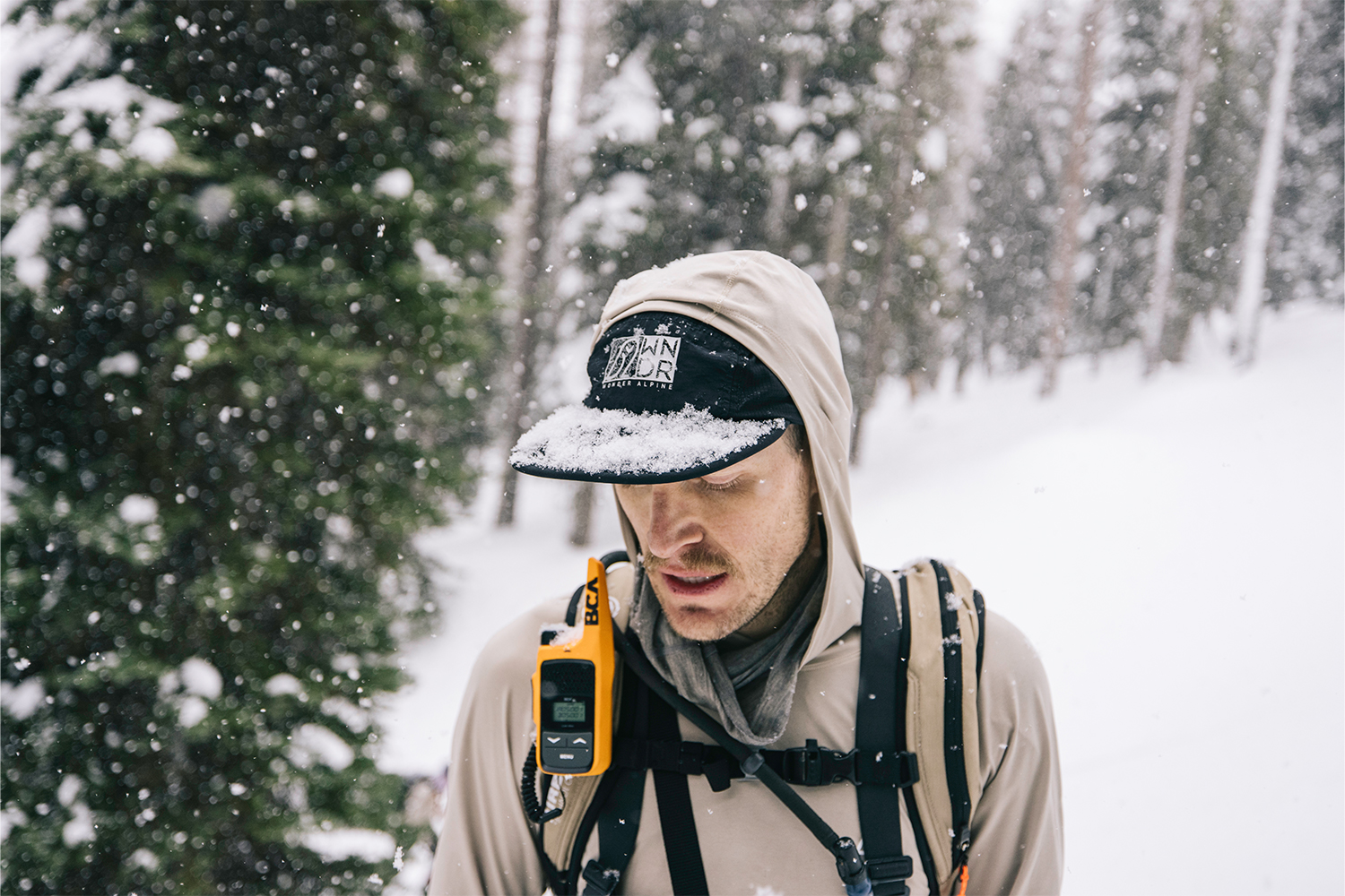 A profile shot of a skier, with snow on his Wonder Alpine cap.