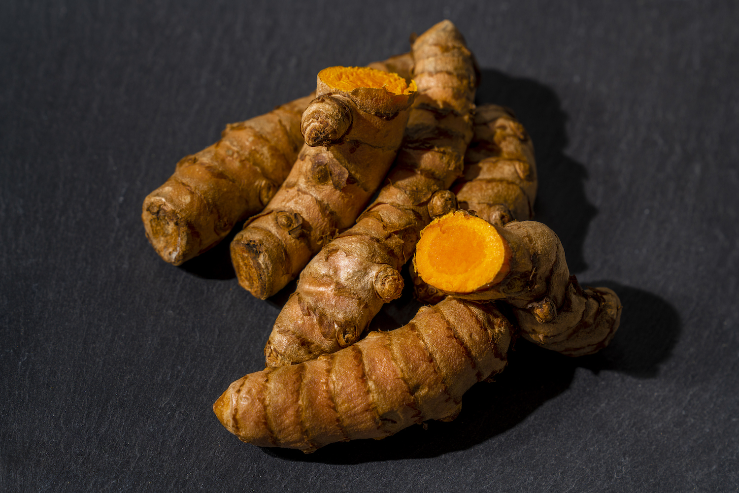 Directly above view of fresh organic turmeric on slate