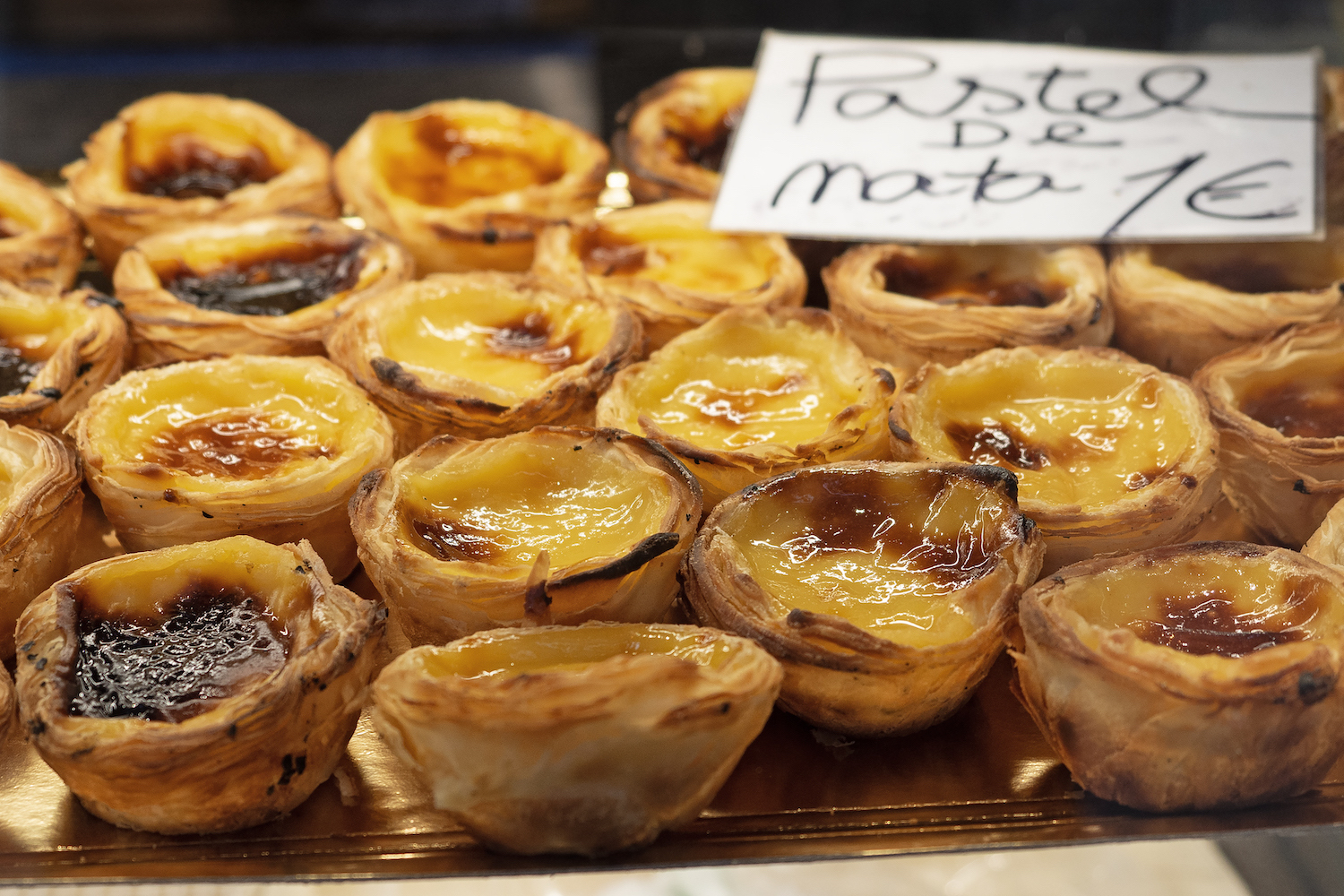 Pastel de Nata tarts for sale at the bakery, close-up, Portugal