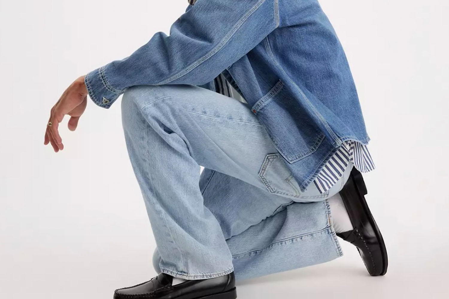 A man wearing Levi's jeans and a denim jacket