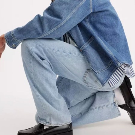 A man wearing Levi's jeans and a denim jacket