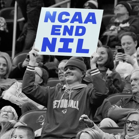 A fan holds a sign reading “NCAA End NIL” at a college basketball game between the Seton Hall Pirates and the DePaul Blue Demons at Prudential Center on January 8, 2025 in Newark, NJ