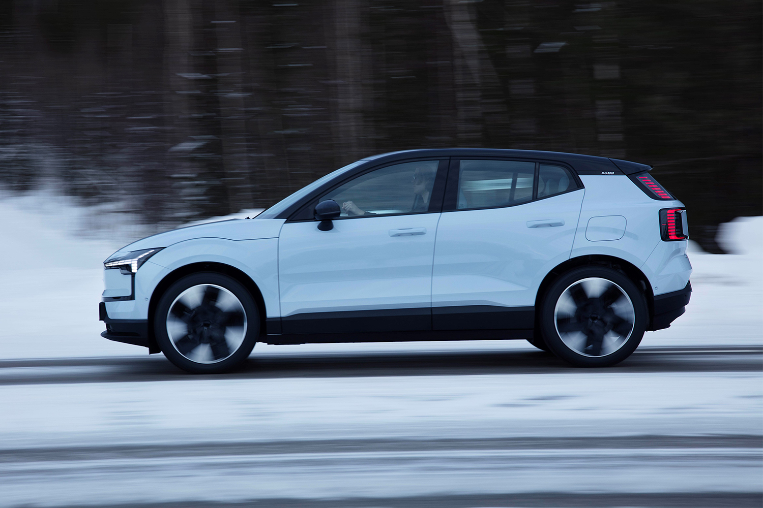 Volvo EX30 electric SUV driving on a winter road