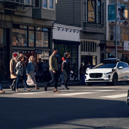 A Waymo vehicle at crosswalk. A new analysis of crash data shows the robotaxis are safer than many people might think.