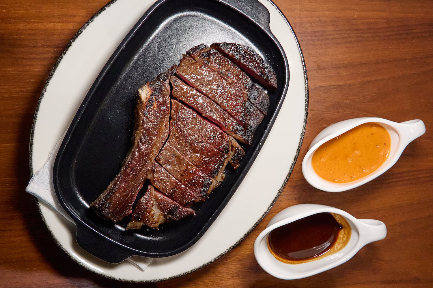 Gui's dry-aged ribeye, served with black garlic bordelaise and gochujang sauce choron