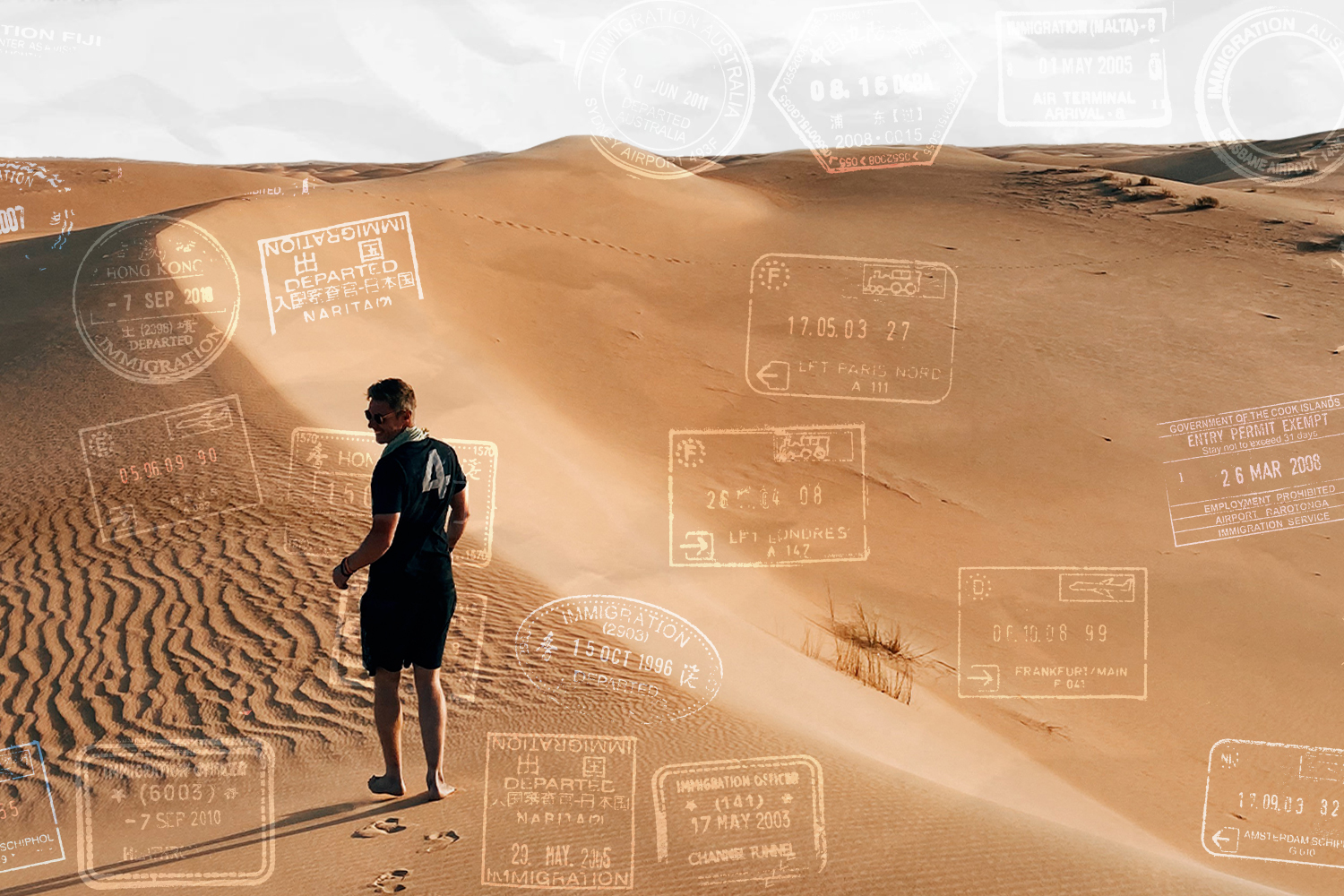 A photo of "Where to Next" host Johnny Ward standing on a sand dune in the desert