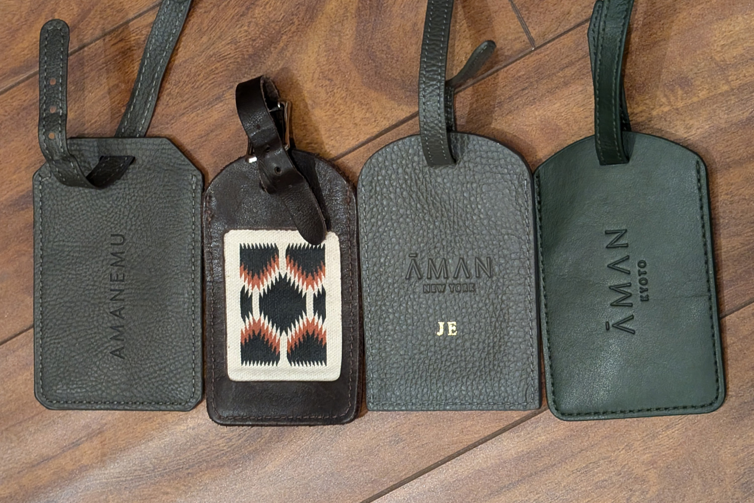 A lineup of luggage tags from Aman resorts