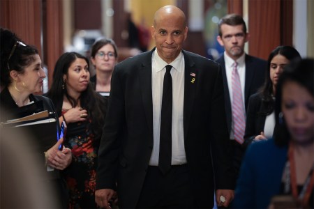 Senator Cory Booker walks through the Capitol surrounded by aides after delivering the longest speech in Senate history, April 2025.