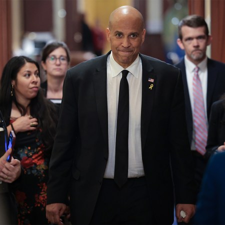 Senator Cory Booker walks through the Capitol surrounded by aides after delivering the longest speech in Senate history, April 2025.