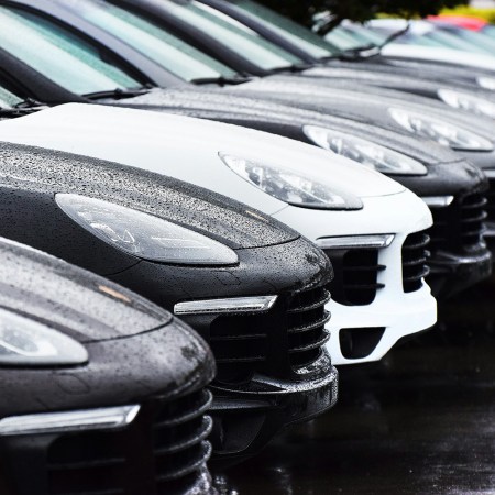 A row of Porsche Macan SUVs in the rain