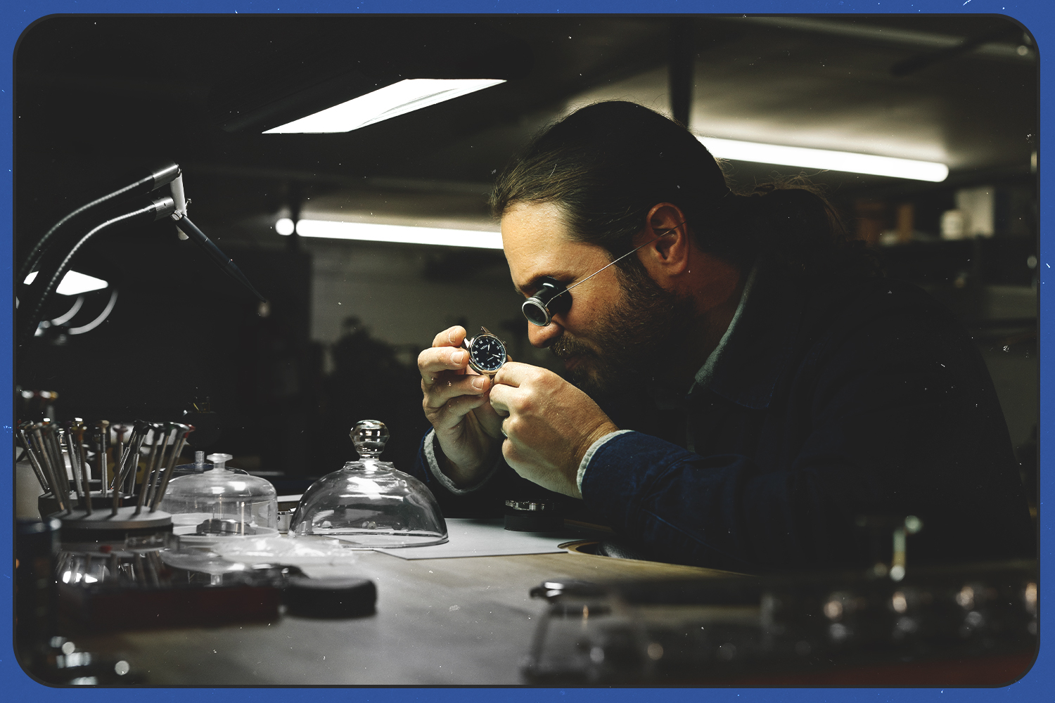 Cameron Weiss, founder and watchmaker at his namesake watch company, inspecting a timepiece