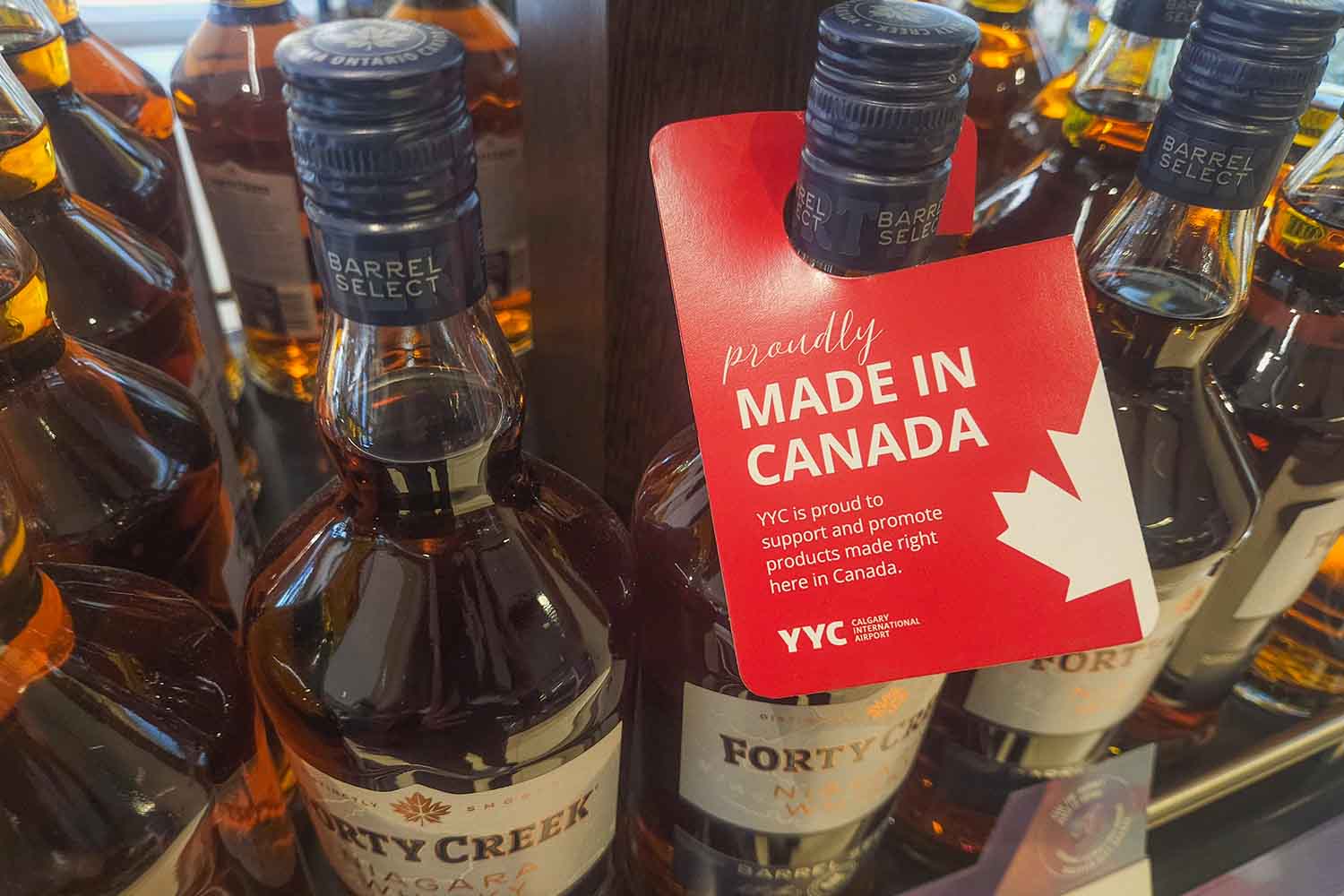 'Made in Canada' stickers placed next to price tags of Canadian Whiskey at Calgary International Airport, emphasizing Canadian-made products at Calgary International Airport, in Calgary, Alberta, Canada, on March 4, 2025. In response to U.S. tariffs on Canadian goods, Canada has enacted countermeasures intended to push the U.S. to remove the tariffs as soon as possible