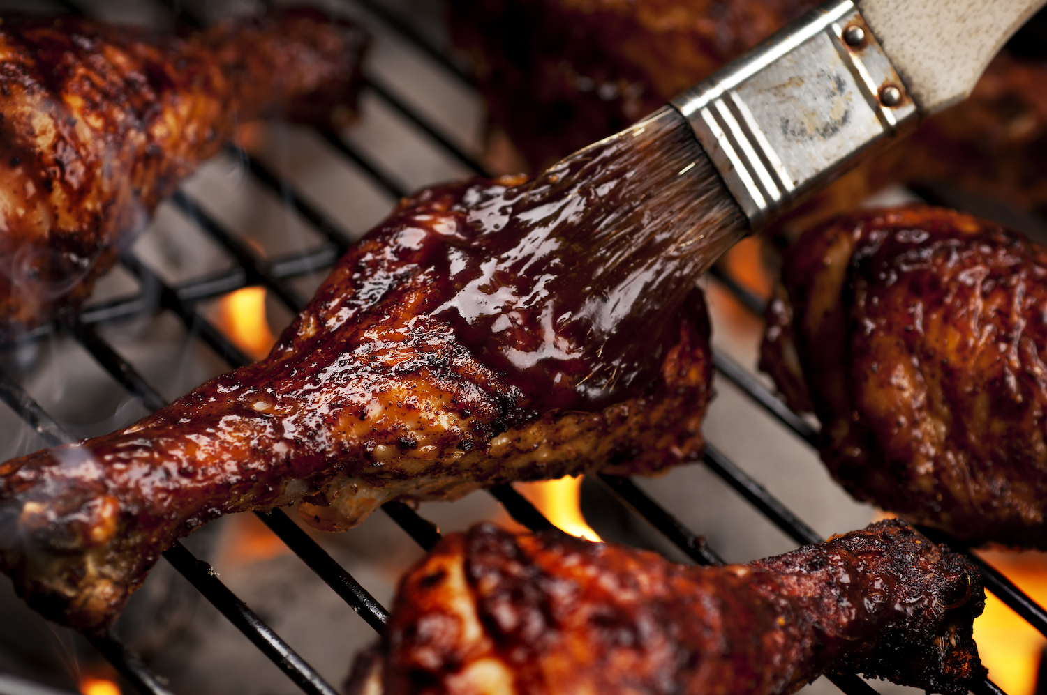 Chicken legs on the grill with barbecue sauce