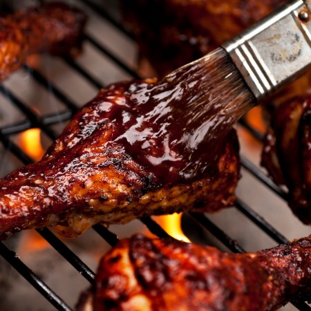 Chicken legs on the grill with barbecue sauce