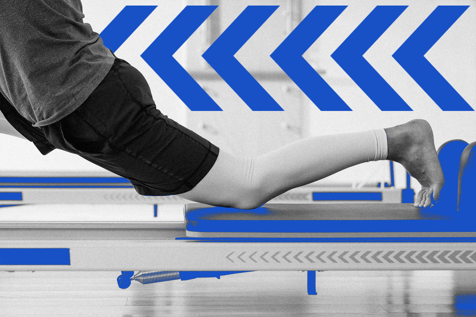 Person performing a leg extension on a Pilates Reformer machine