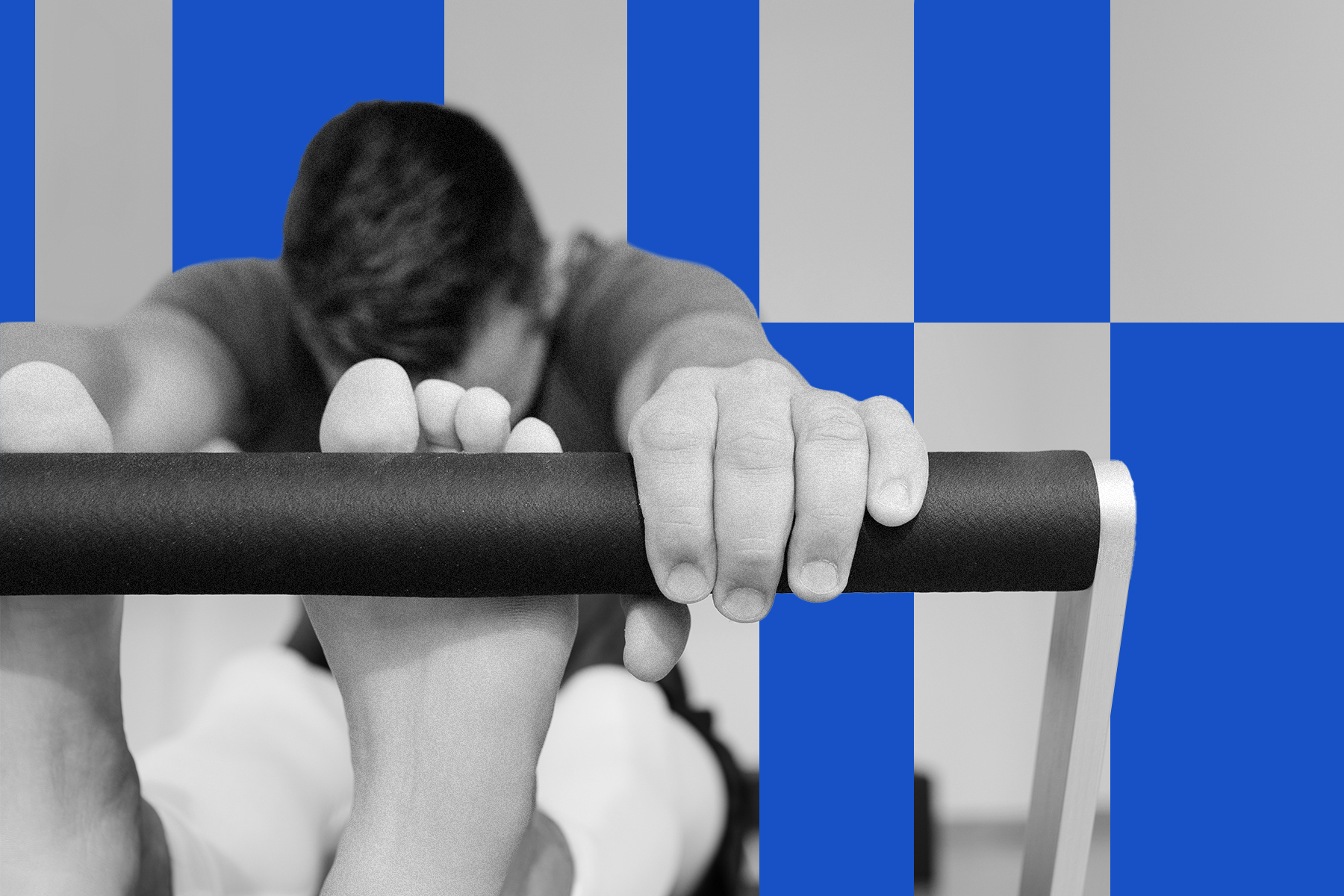A person gripping a Pilates Reformer bar with their hands and feet in position