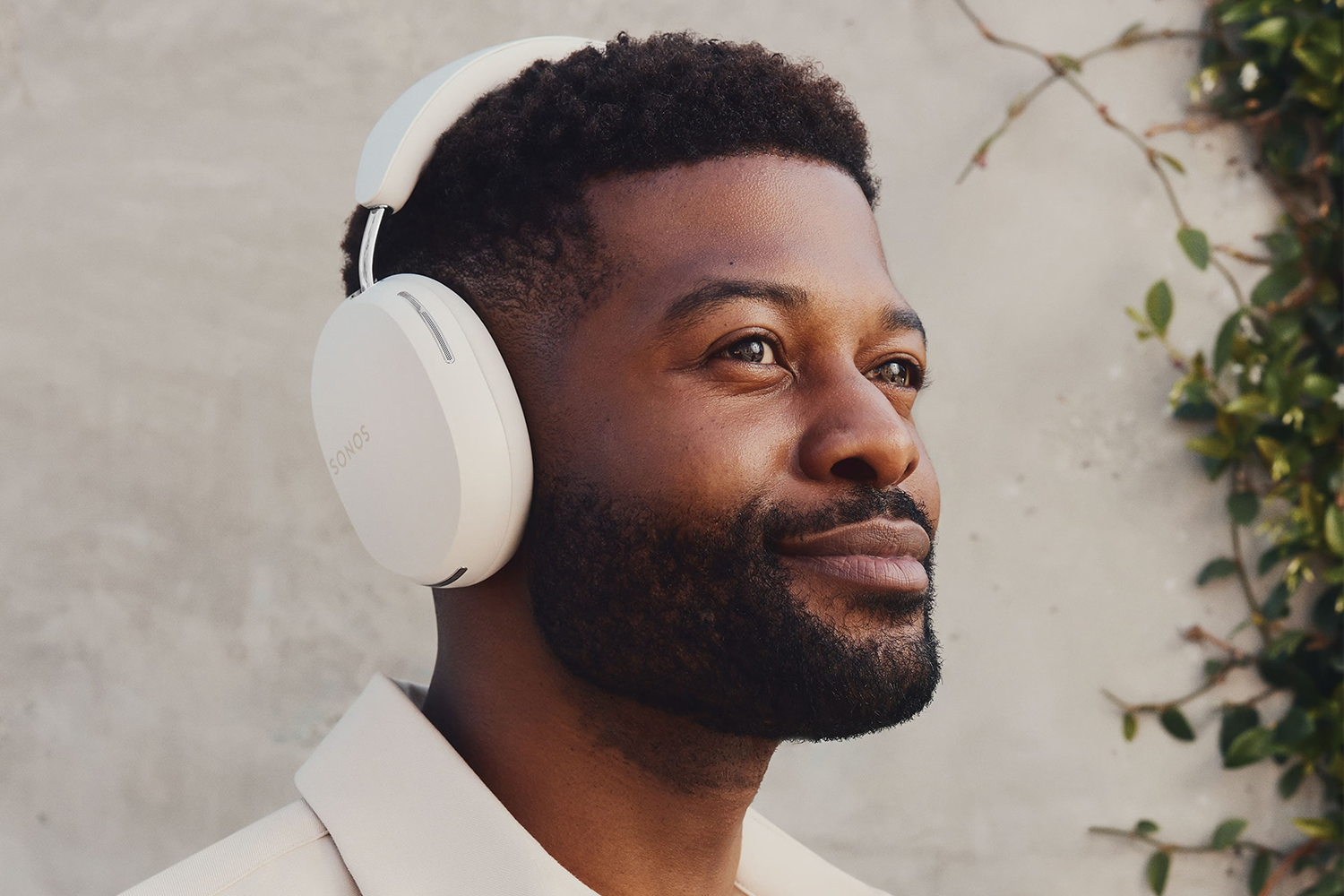 a man wearing white over-the-ear headphones
