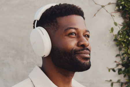 a man wearing white over-the-ear headphones