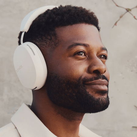 a man wearing white over-the-ear headphones