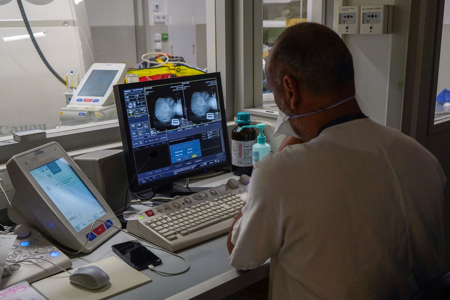 A doctor looking at computer screens