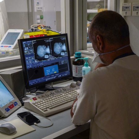 A doctor looking at computer screens