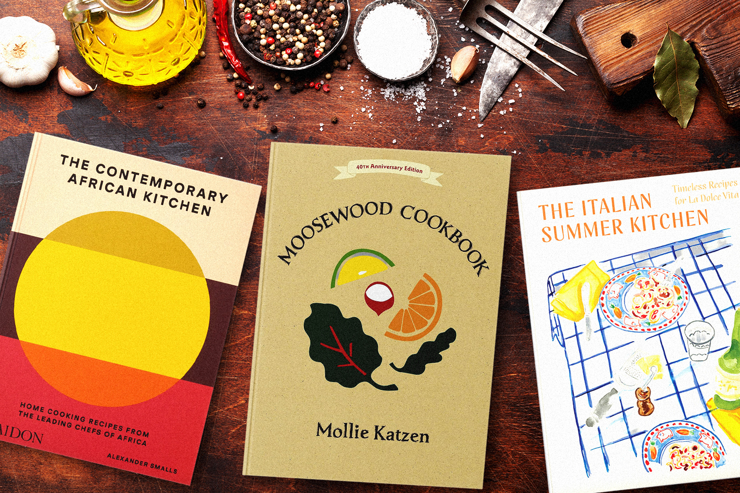 cookbooks on a kitchen table with tools and ingredients