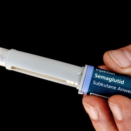 hand holding a semaglutide injector
