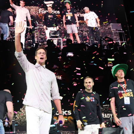 Tom Brady waves as confetti falls