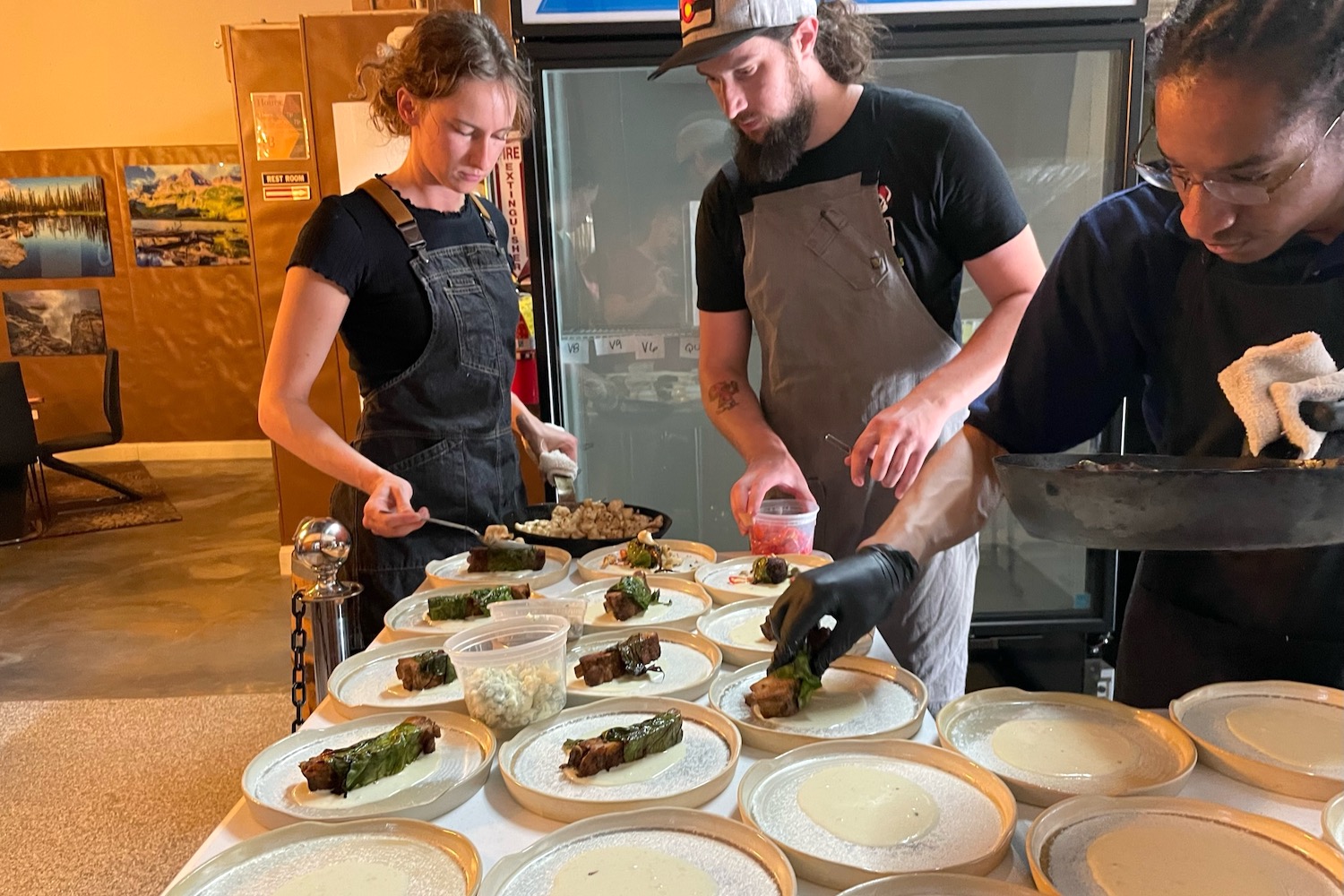 Chefs plating dishes at a recent beer dinner hosted by Thistle & Mint