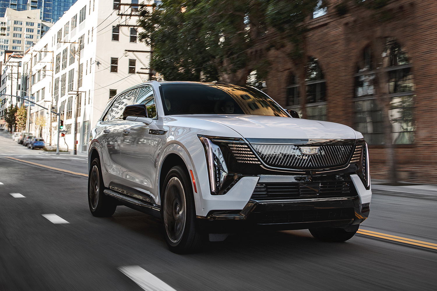 The electric Cadillac Escalade iQ SUV driving down the road
