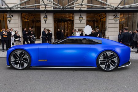 The Jaguar Type 00 concept car in blue sitting next to a curb during Paris Fashion Week