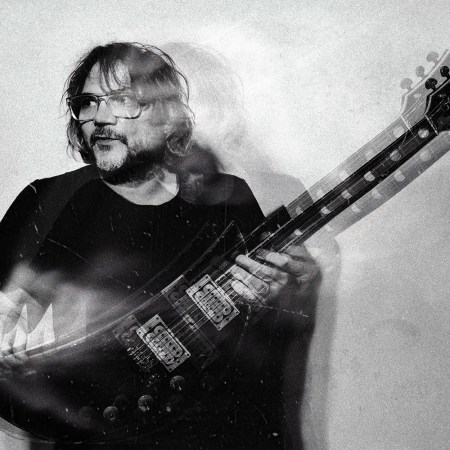 Jeff Tweedy holding a guitar in the album art for his new triple LP "Twilight Override"
