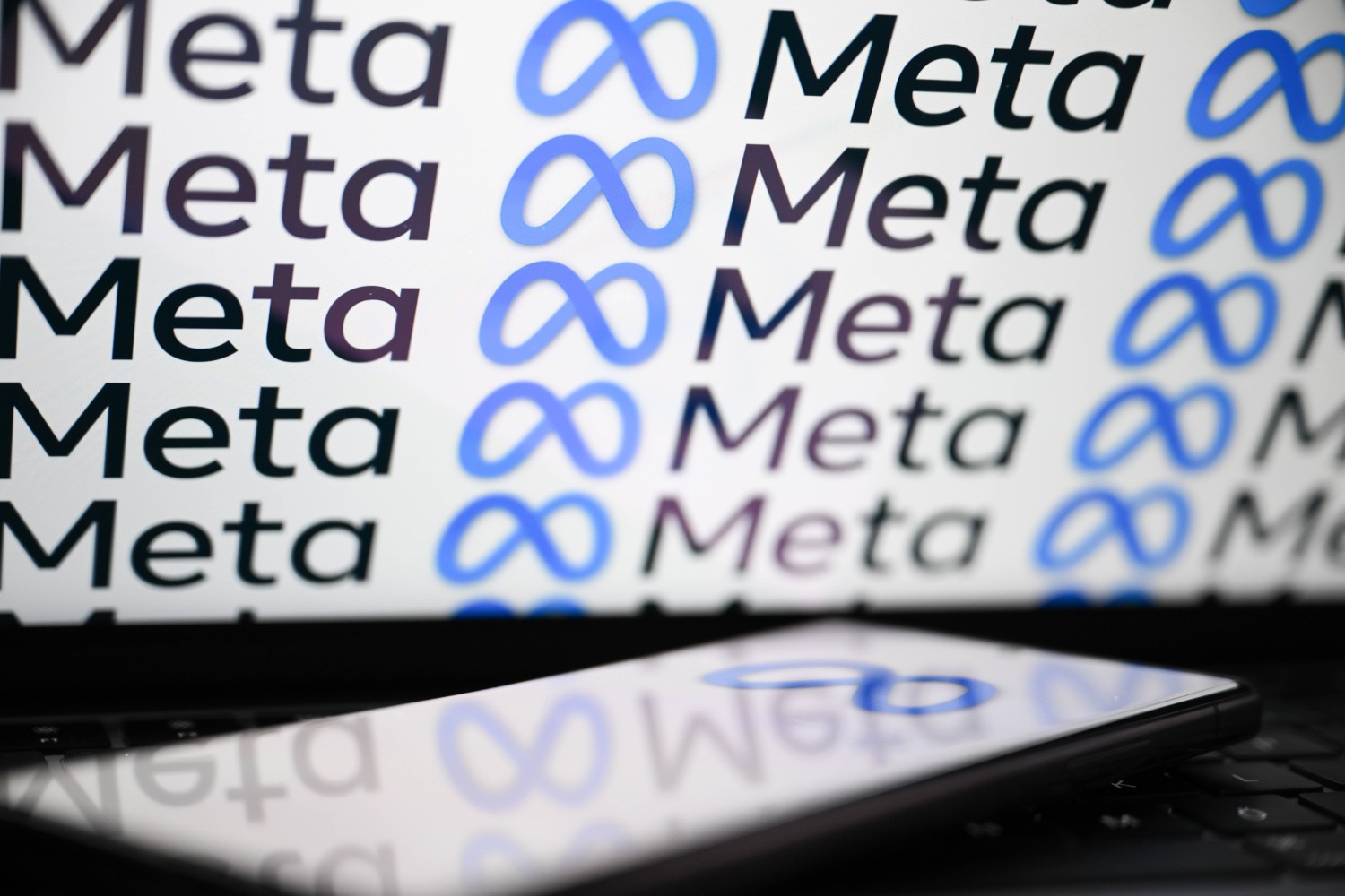 Meta logo on laptop and phone