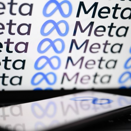 Meta logo on laptop and phone