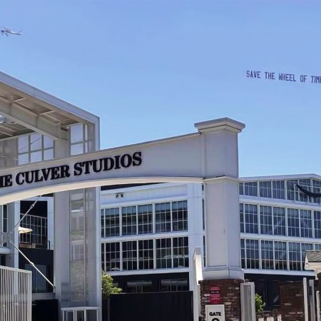 An airplane with a sky banner that reads "Save The Wheel of Time - #SAVEWOT" flying over Culver Studios, which includes Amazon MGM Studios