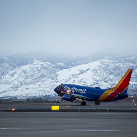 Southwest Airlines flight taking off with mountains in the background