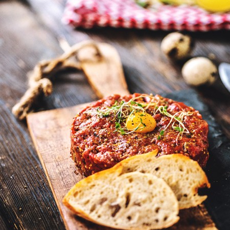 Delicious Beef tartare with quail egg and spices