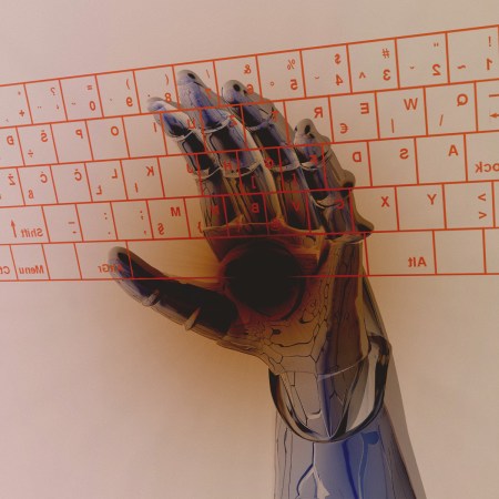 A robotic arm typing on a keyboard