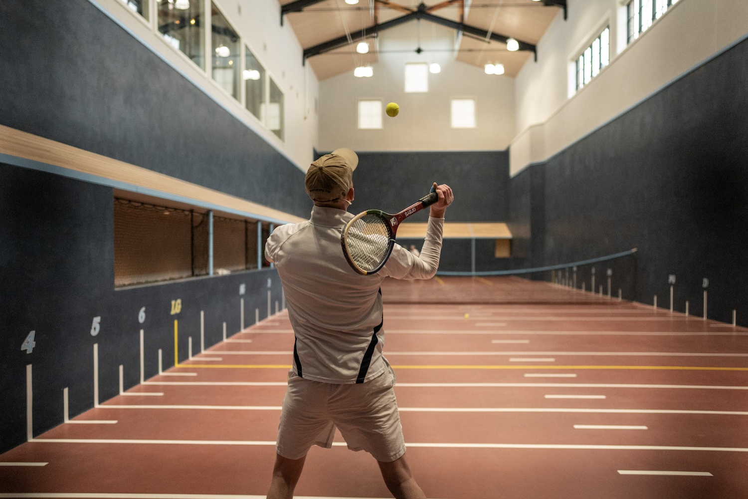 A man playing "real tennis" at Sand Valley Resort.