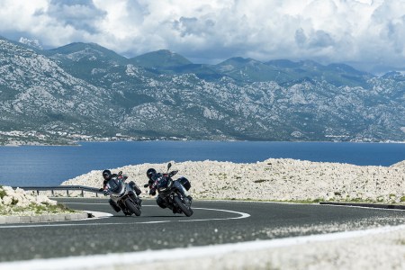 Two motorcyclists lean into a corner on the Adriatic Highway in Croatia