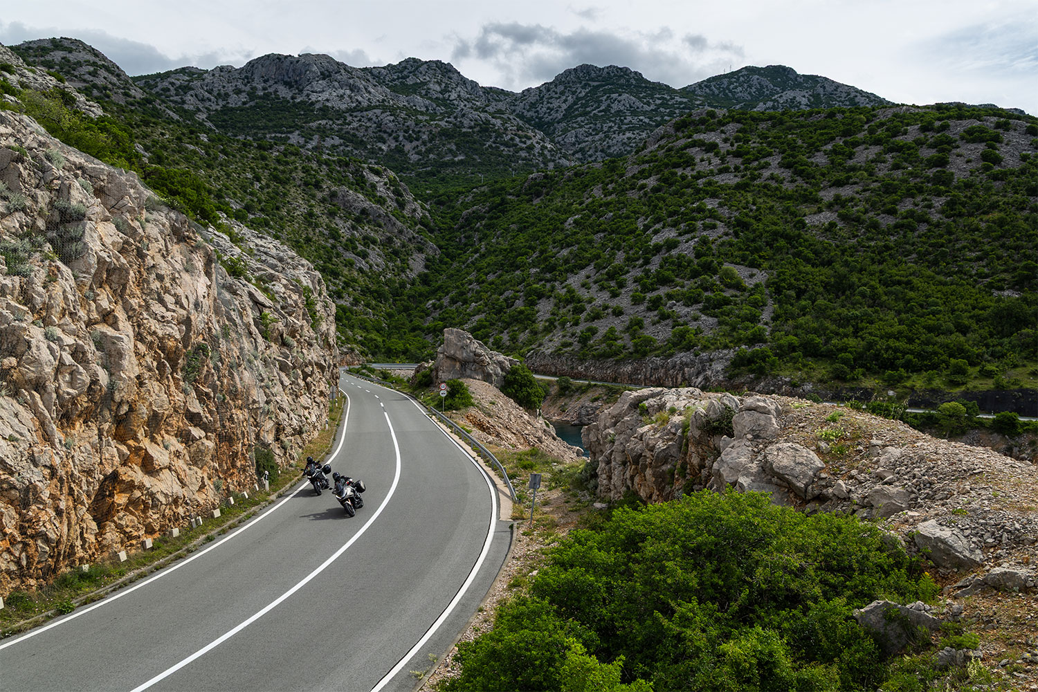 Two motorcyclists riding a mountain highway in Croatia