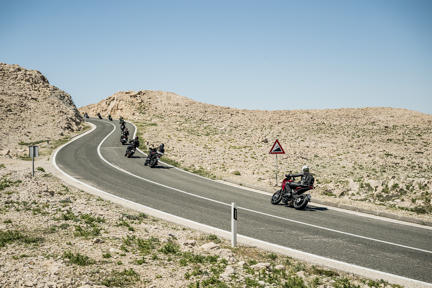 A group of motorcycle riders ascending a hill on the Adriatic Highway in Croatia