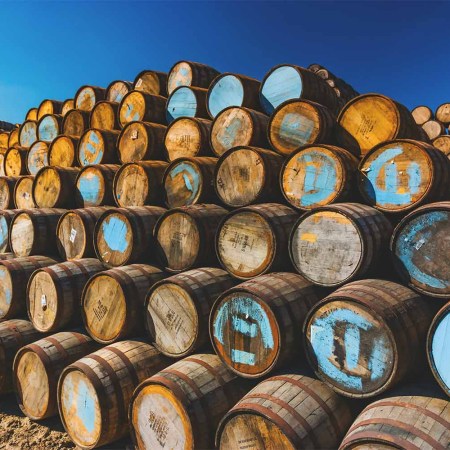 Whisky barrels stacked at a cooperage in Scotland