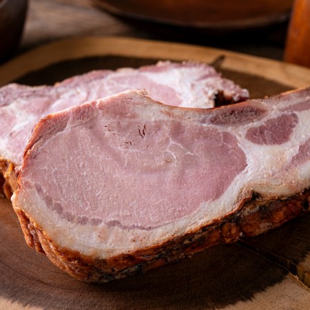 Delicious smoked pork chops on a rustic wood cutting board